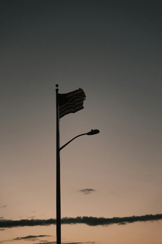 a street light sitting next to a sign post