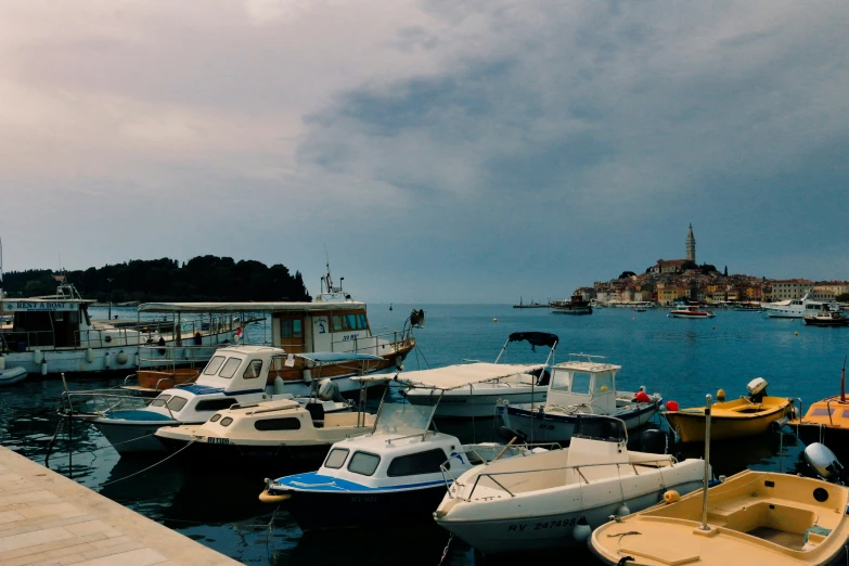 boats sitting on the water in front of a town