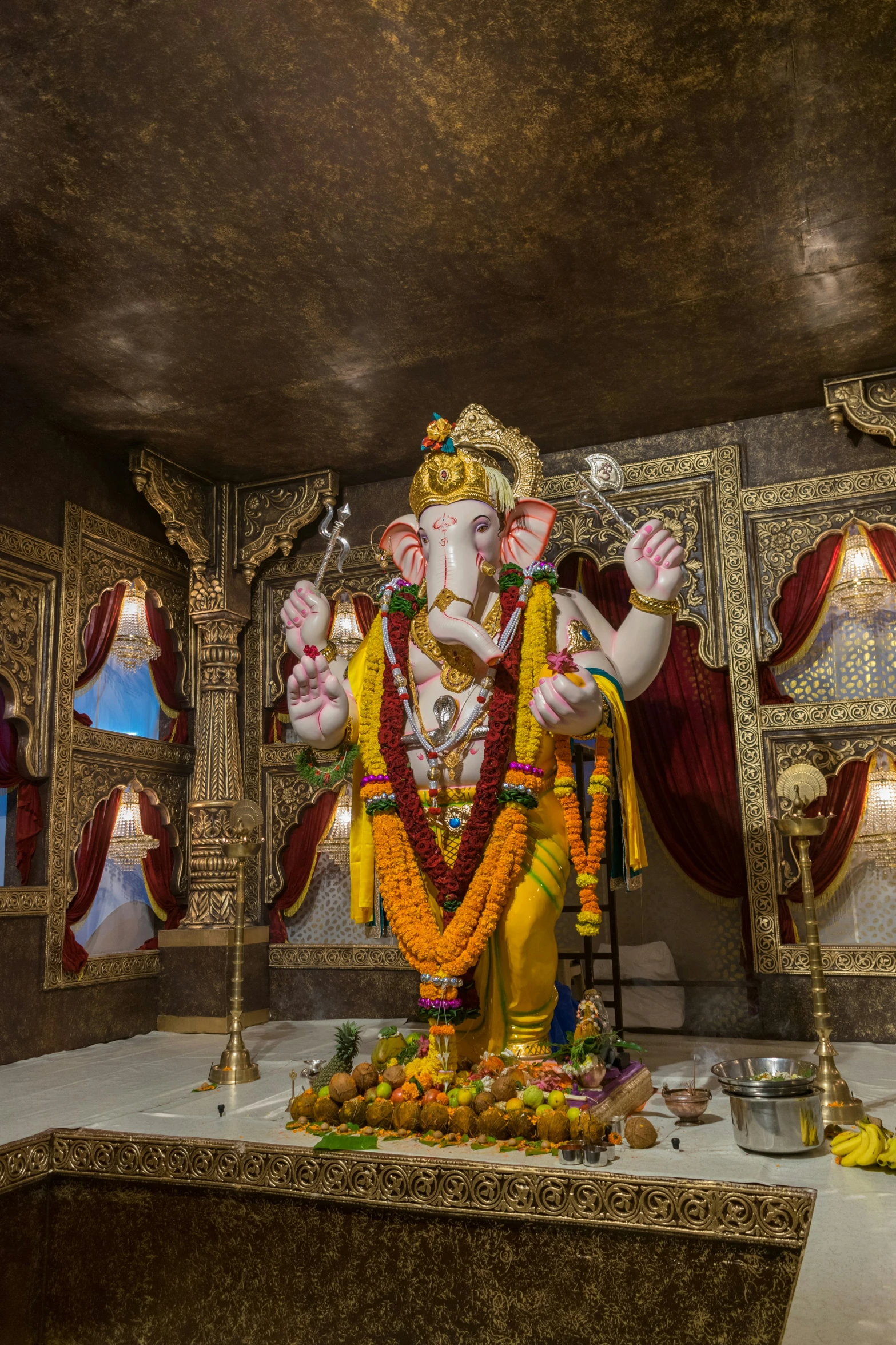 a statue of the god ganpatia sits on a platform