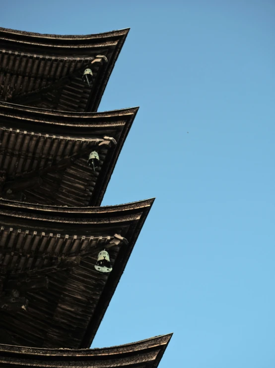 four steeples and blue sky with a bird flying in the sky