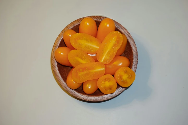 there are a bowl full of tomatoes on the table