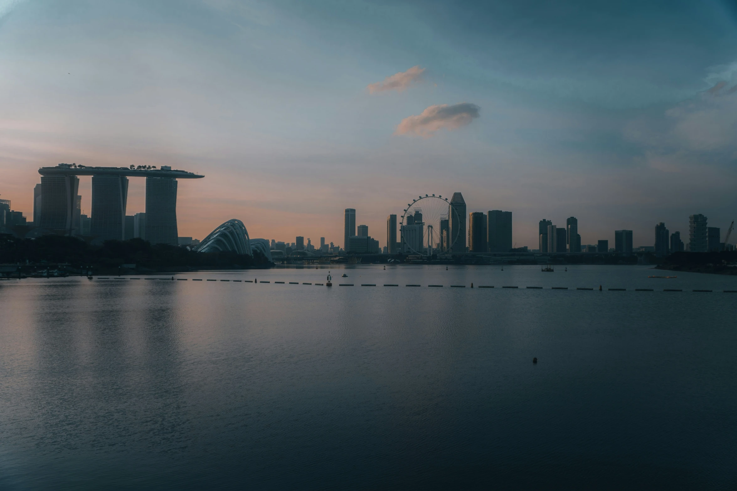 the large body of water with tall buildings in the distance