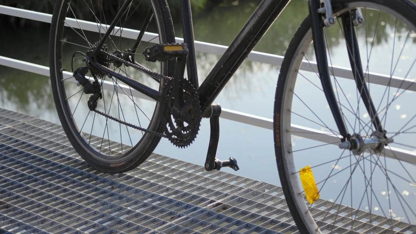 a bicycle is parked on a dock by the water