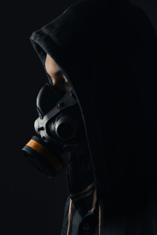 a man wearing a gas mask while holding a black object
