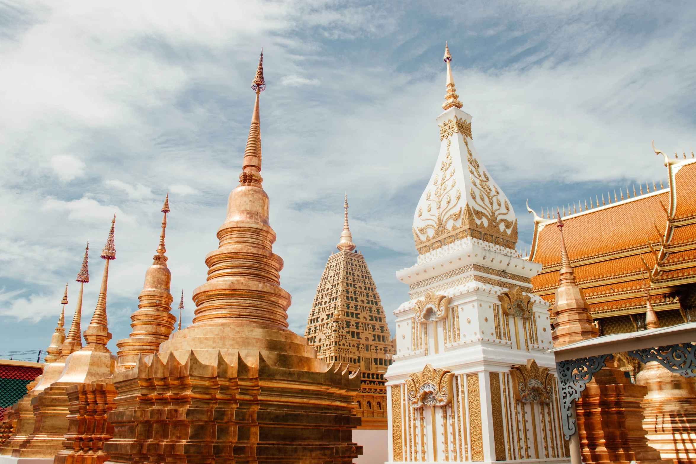 golden towers and other large buildings under blue sky