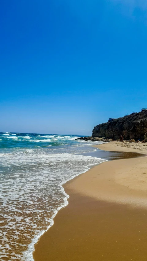 a beach with a very long line of waves