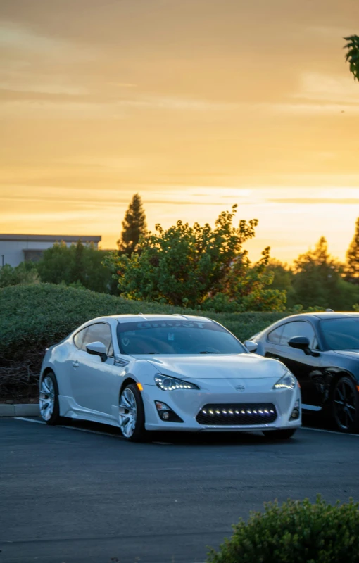 two cars parked next to each other on a road