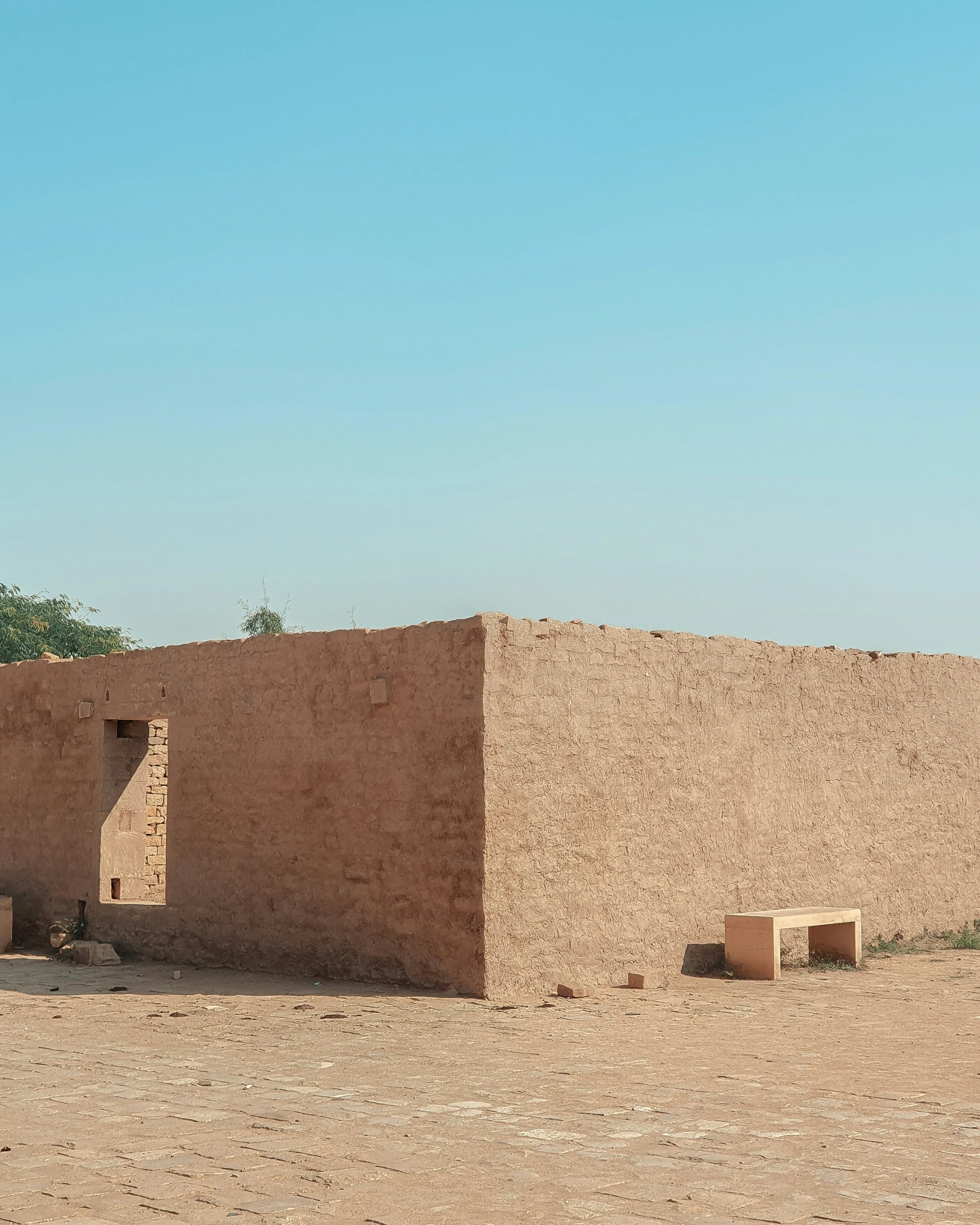 a desert home sitting on top of a dirt field