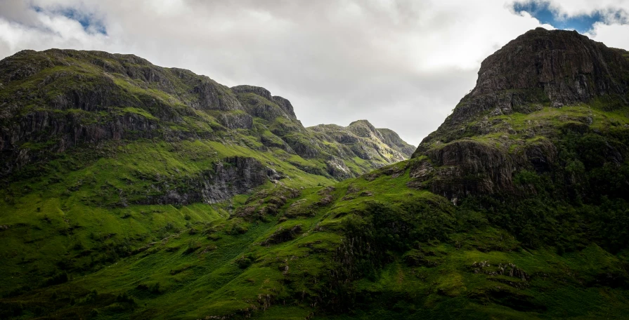 an expanse of hills is shown with clouds