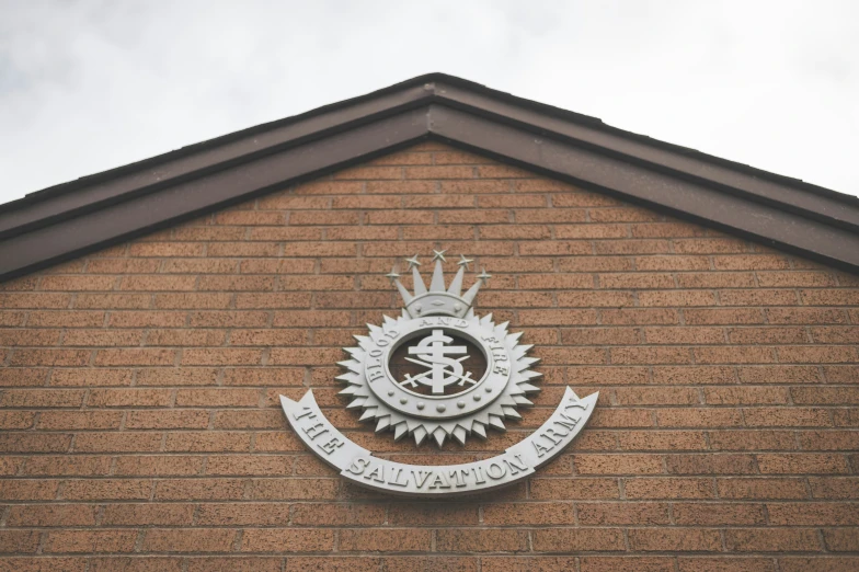 a brown building with an emblem on the side