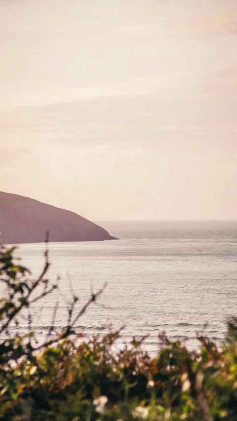 a distant hill sits in the distance with water around it