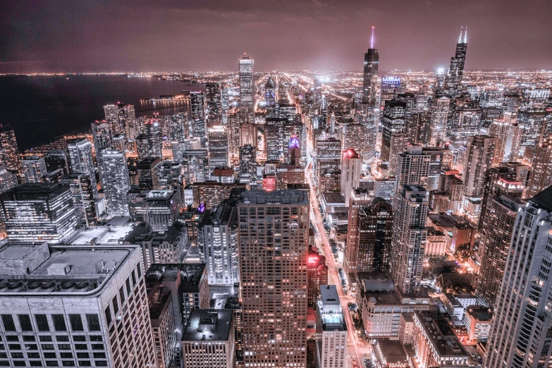 a night view from above of city skylines and buildings