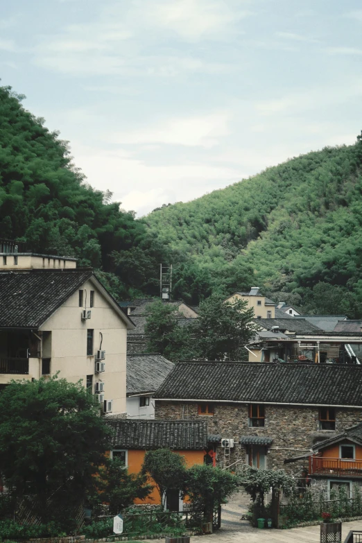 some buildings some hills and trees and a hill