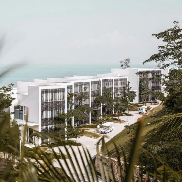 a white building in the daytime with view over a lake