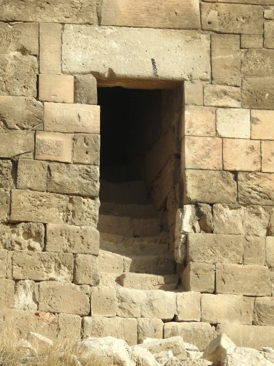 a stone wall and steps in a small building