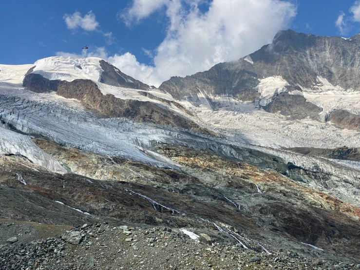 a snowy mountain, with a mountain pass and some very steep peaks