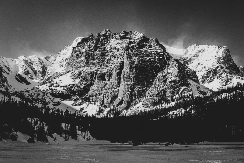 a black and white pograph of a snow covered mountain