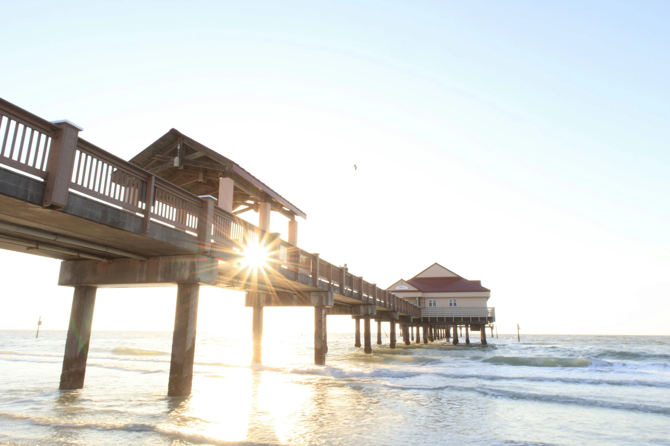 sunset in front of an ocean front pier