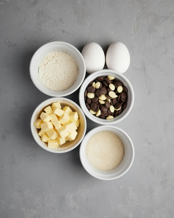 four bowls that have food in them on top of a table