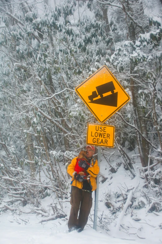 a person poses in front of a sign