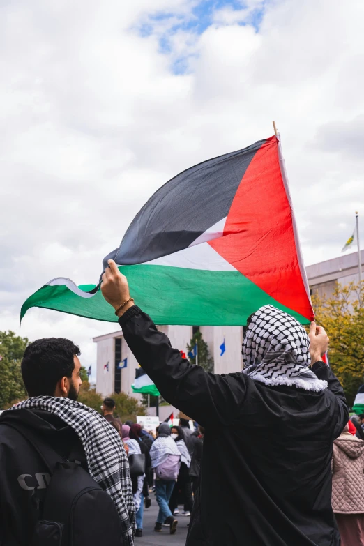 people holding a flag that is not very big