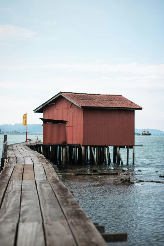 a boat dock is seen with a red house on it