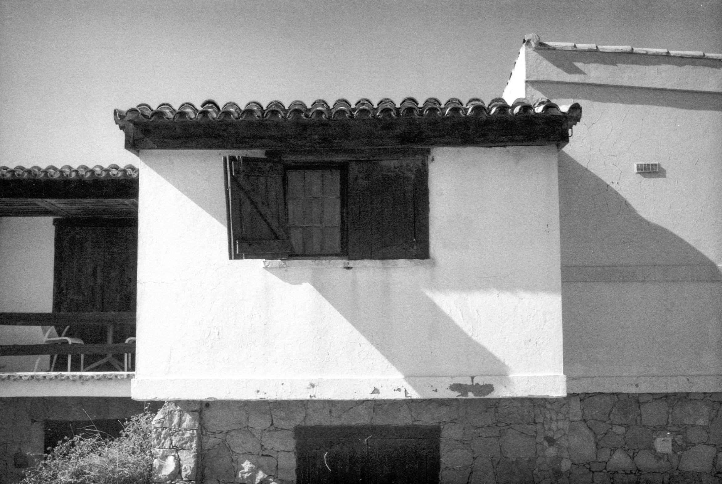 a small house with a horse standing in front of it