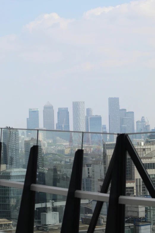 a view of the skyline and some buildings from the top of a hill