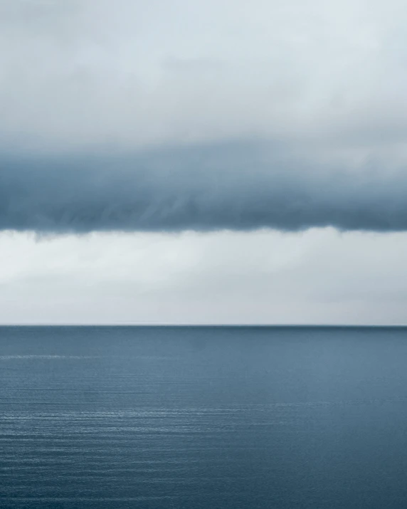 a boat is out in the water under a dark sky