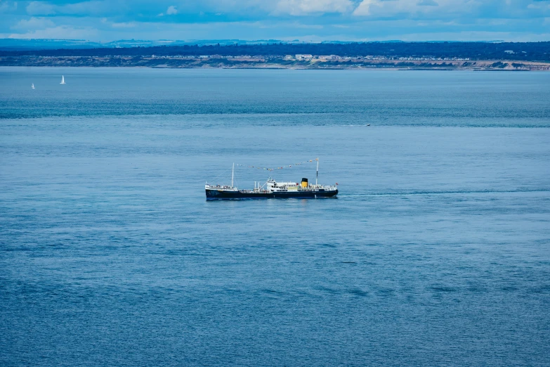 a boat is sailing across a calm blue sea