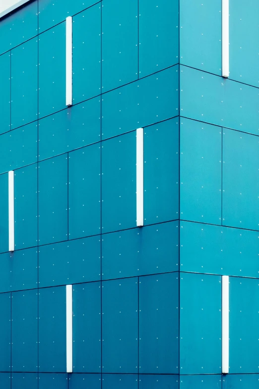 a blue building has two windows in it