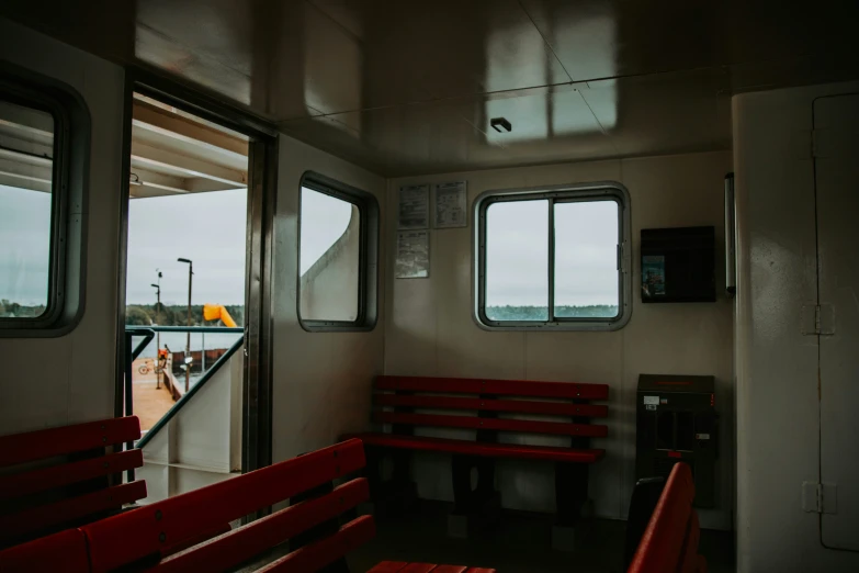 a red bench sits on a narrow deck