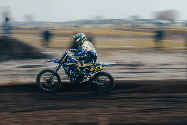 a dirt bike rider riding in the mud