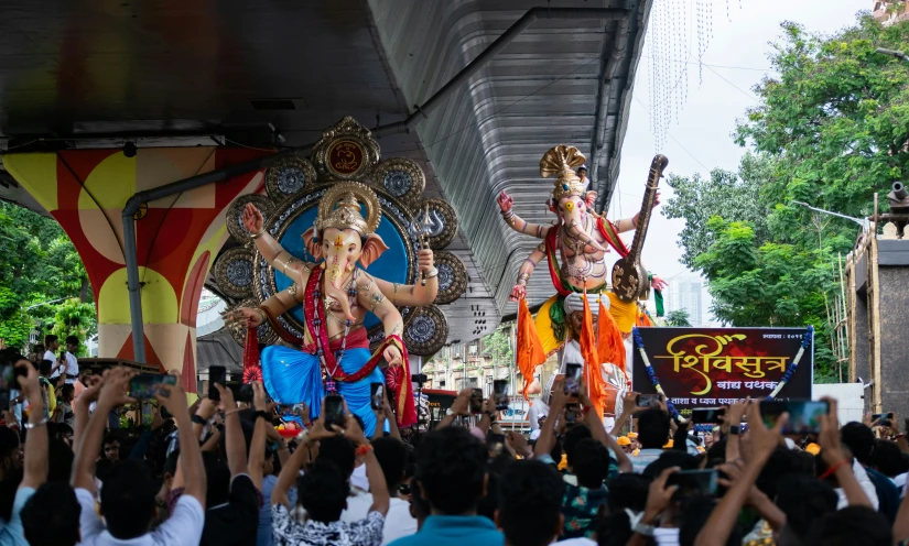 a group of people standing on top of wooden chairs in front of a crowd