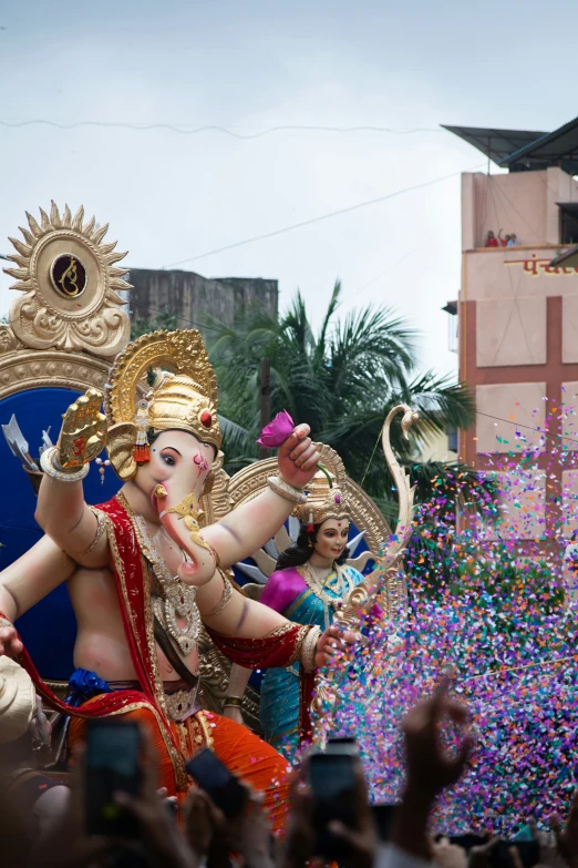 a man riding a giant elephant in a parade