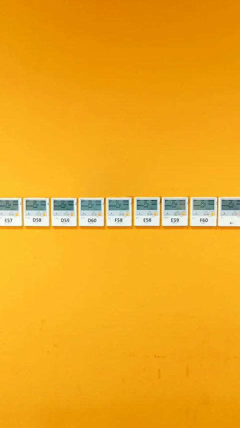 yellow and silver wall with multiple different electrical sockets