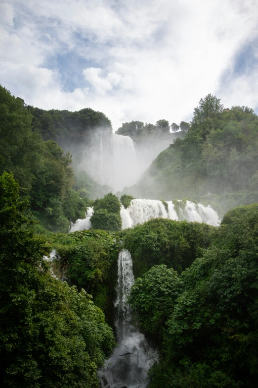 a large waterfall coming out of the top of a mountain