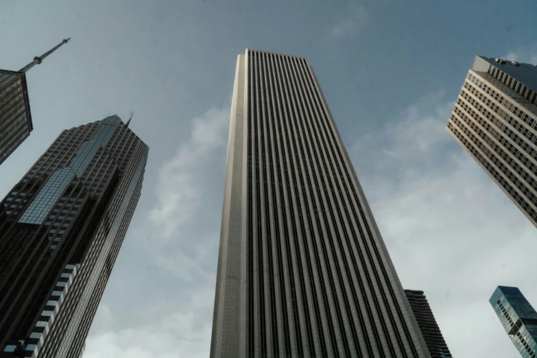 looking up at skyscrs from below in a blue sky