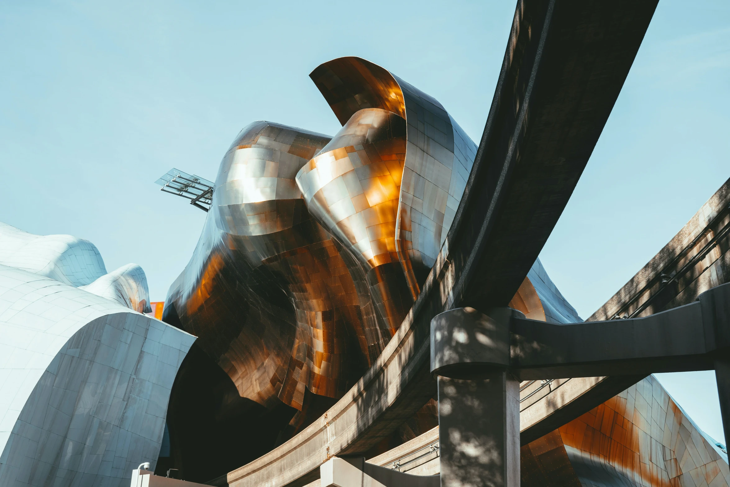 a silver sculpture sitting in front of a building