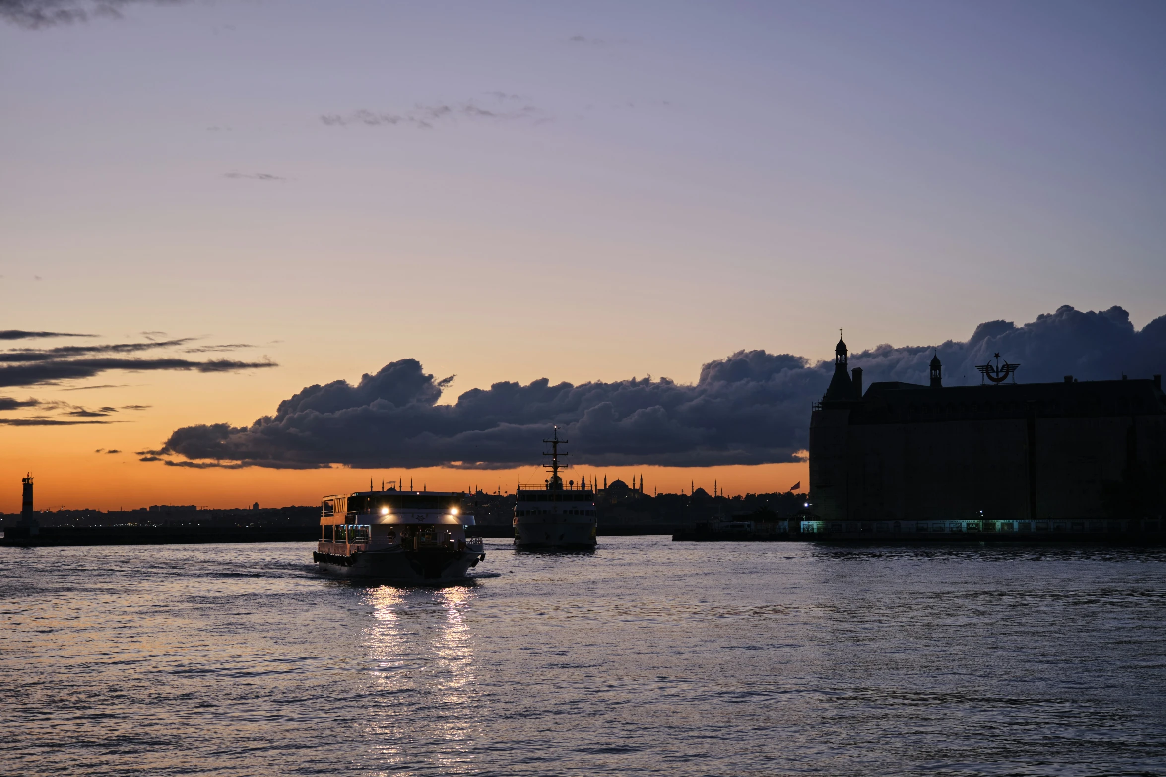 several boats are in the water and at sunset