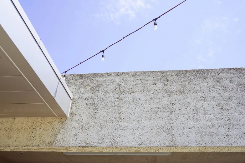 an empty building sitting beside a string light on the roof