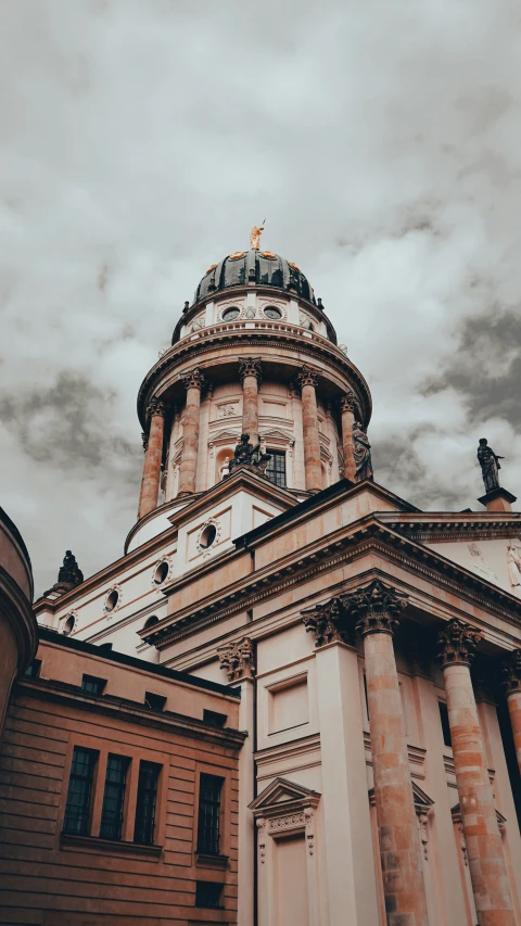 the building has many statues on the roof