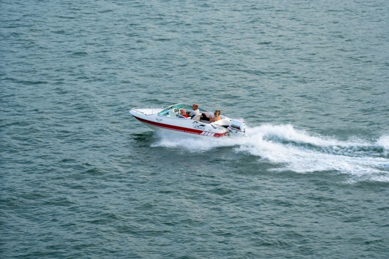 a small boat is in the ocean with people on it