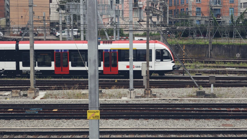 a red white and blue train and some wires