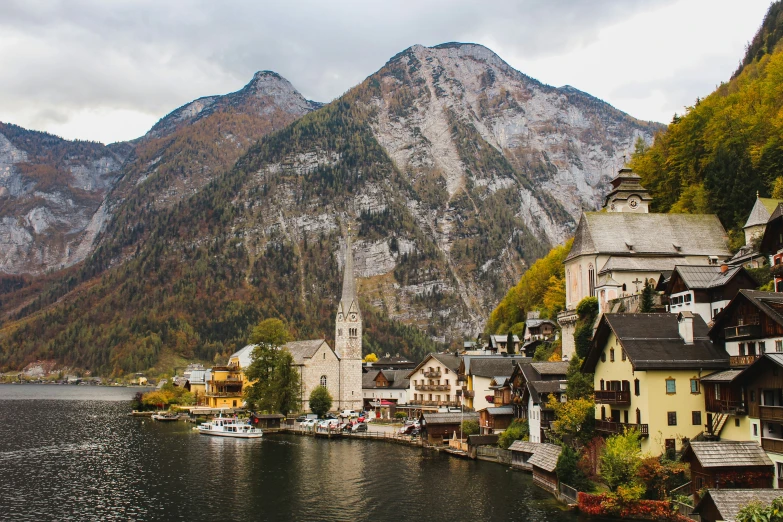 a mountain village sits in front of a river