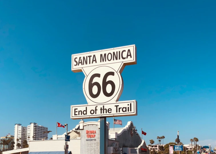 a tall road sign is next to the side of a street