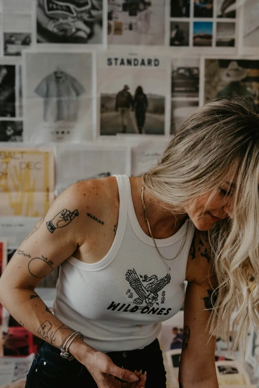 a woman bending down with tattoos on her back