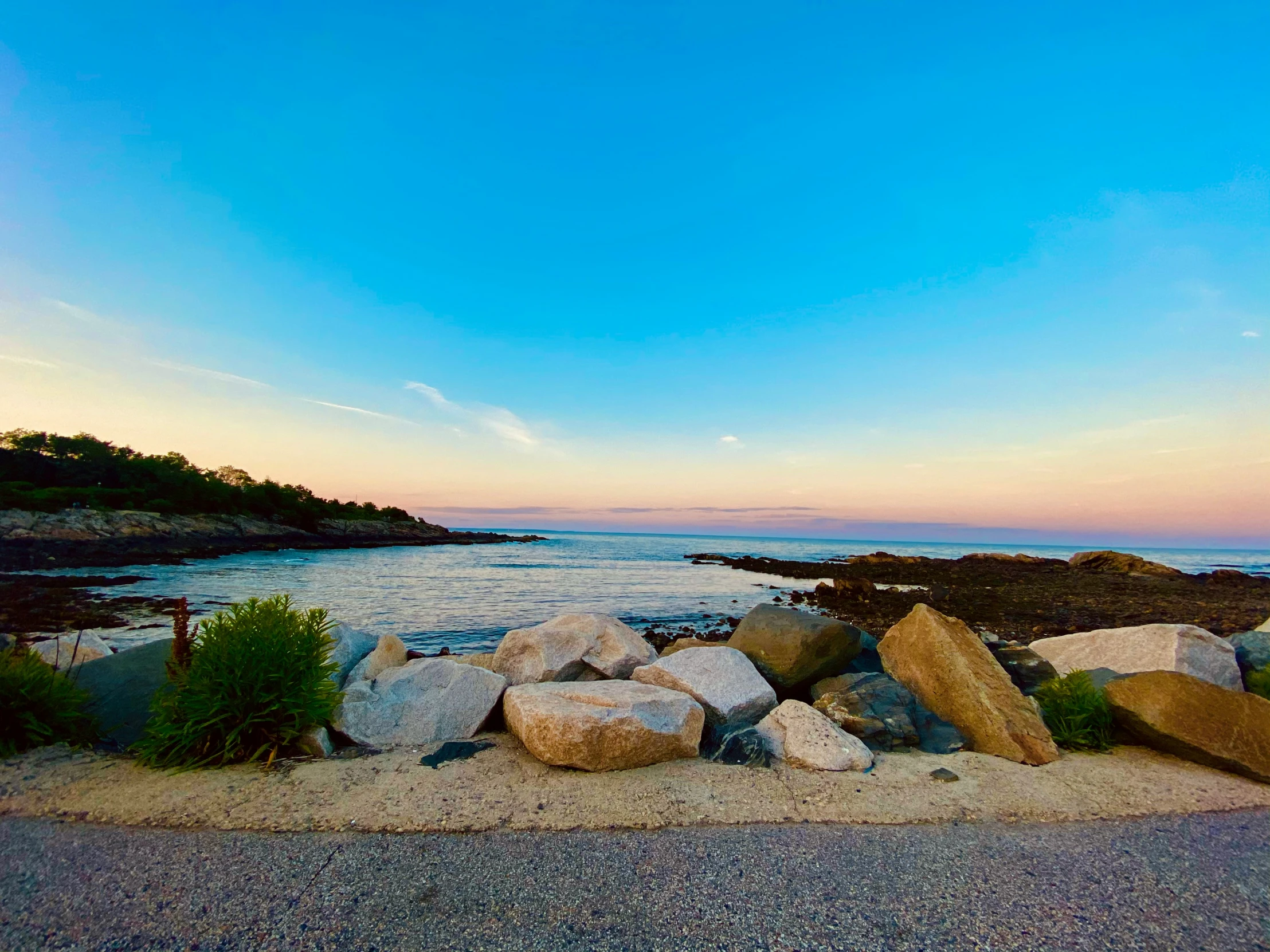 a very nice looking beach with some rocks by the water