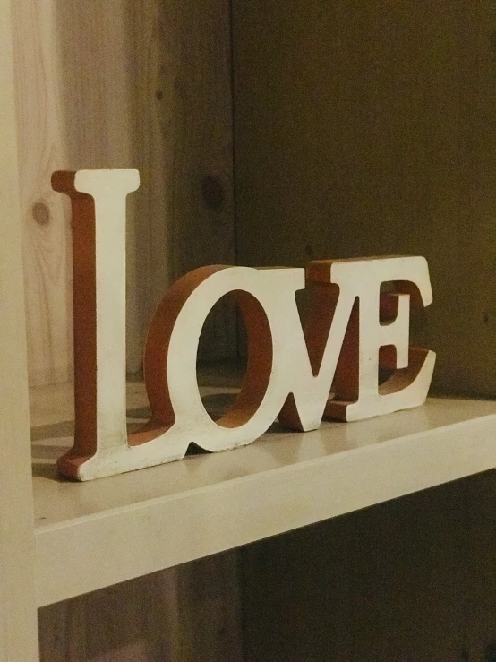 the words love are wooden cut out of wood