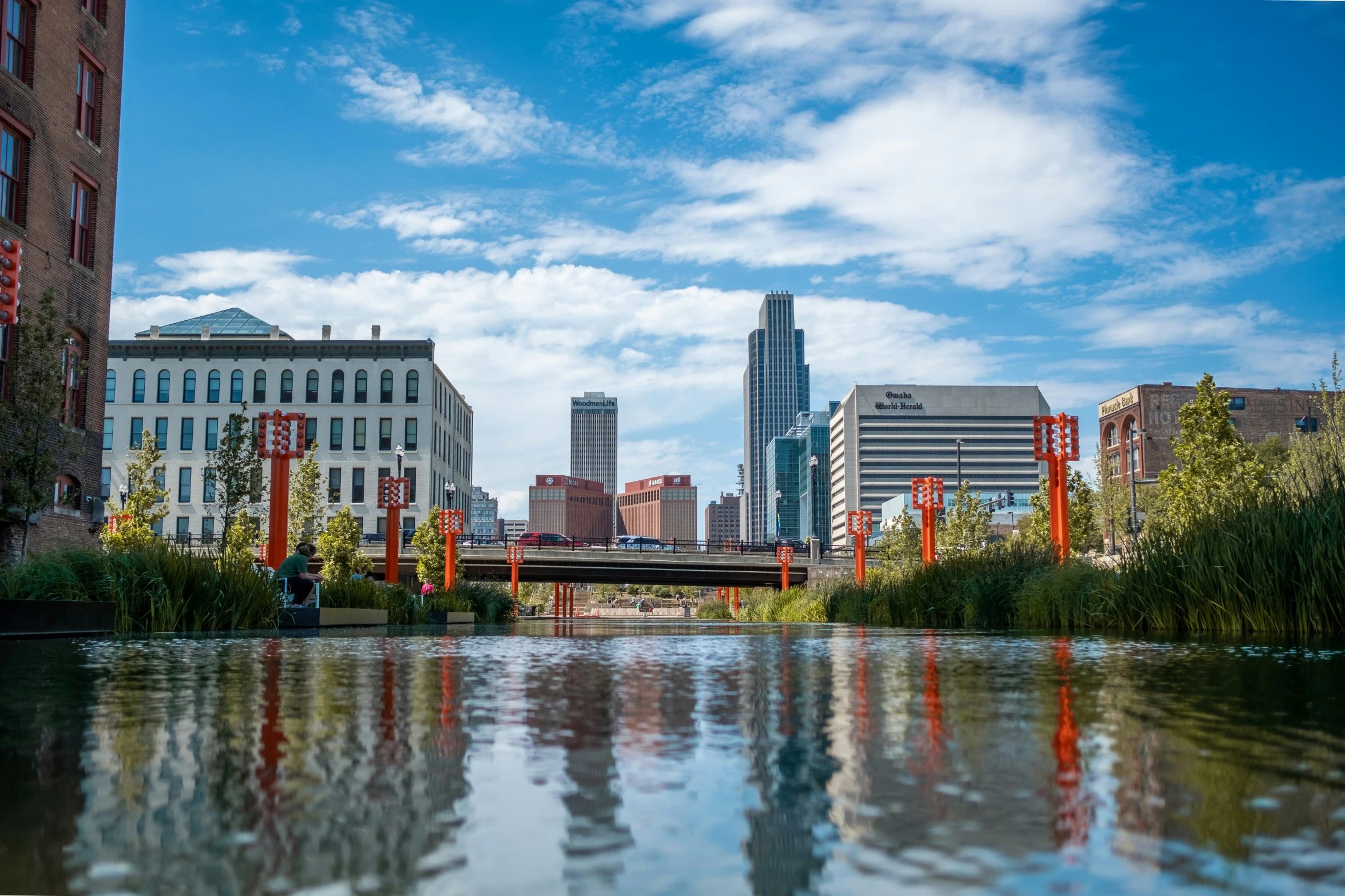 buildings and water reflecting the clear sky in the background